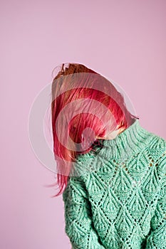 Girl shaking her Beautiful young girl with dyed hair on color backgroundpink hair