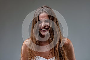 Girl in sheath dress laughs uncontrollably