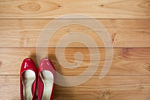 Girl shoes over wooden deck floor.