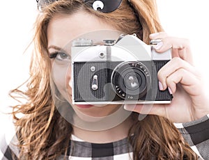 GIRL IS SHOOTING WITHA A RETRO CAMERA photo