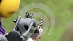 Girl Shoots a Shotgun Close Up. Slow Motion.