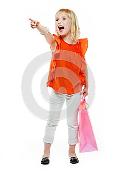 Girl with shopping bag on white background pointing on something