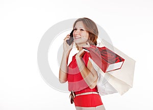 Girl with shopping bags calling by mobile phone