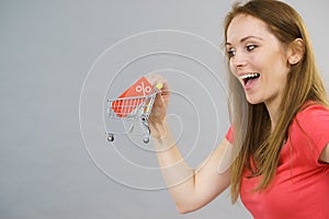 Girl with shopping cart and sale tag