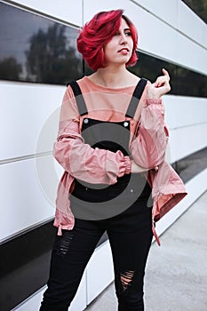 Girl with short pink hair in autumn clothes