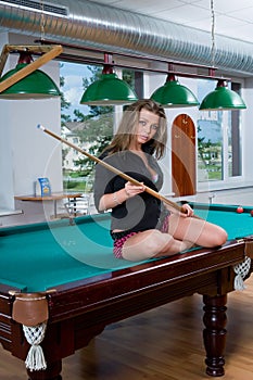 Girl in short skirt playing snooker