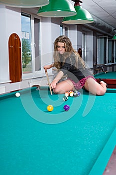 Girl in short skirt playing snooker