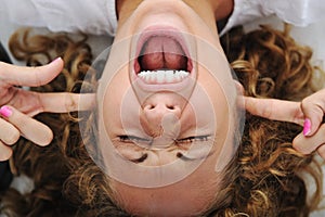 Girl shouting with fingers in ears