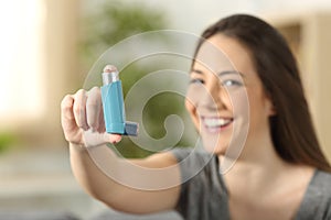 Girl showing an asthma inhaler