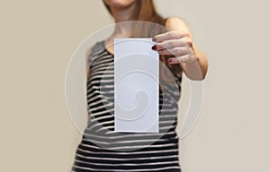 Girl showing blank white flyer brochure booklet. Leaflet present