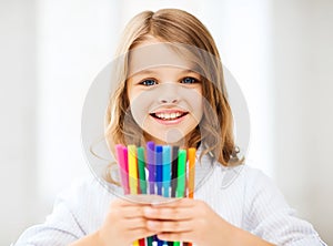 Girl showing colorful felt-tip pens