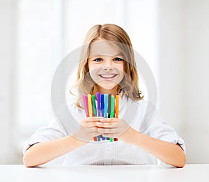 Girl showing colorful felt-tip pens photo