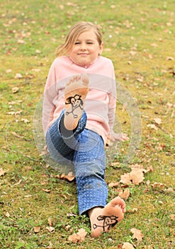 Girl showing drawen hearts on soles