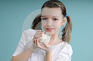 Girl showing glass with milk