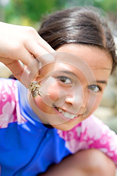 Girl showing her little hermit crab