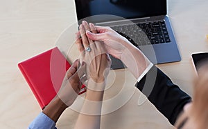 Girl showing her ring to her female colleagues