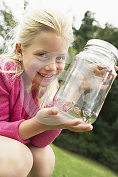 Girl Showing Insect In Jar