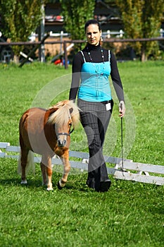 Girl showing a mini pony photo