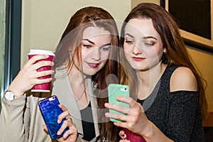 Girl showing mobile phone to a friend