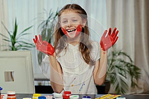 A girl showing painted hands.