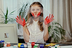 A girl showing painted hands.