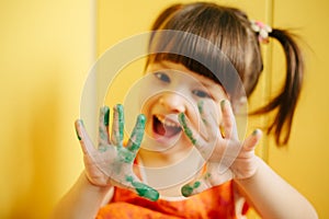 Girl showing painted hands. arms