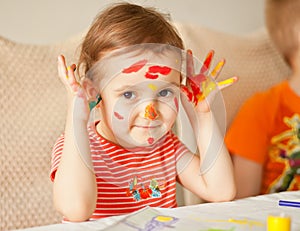 Girl showing painted hands. Hands painted in colorful paints. Education, school, art and painitng concept