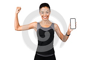 Girl Showing Phone Blank Screen And Biceps Posing, White Background