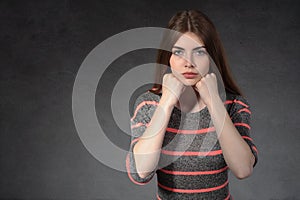 Girl shows concentration against a dark background