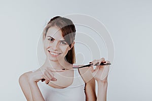 Girl shows the finger on the toothbrush smile teeth