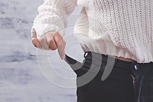 Girl shows her empty pockets