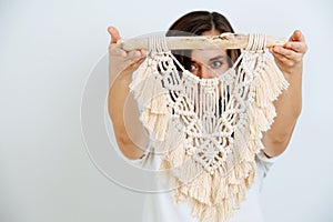 The girl shows macrame on her hand