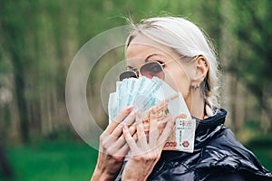 Girl shows off a wad of money