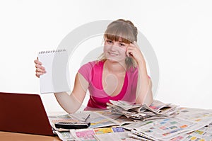 Girl shows record on a notepad while sitting at table