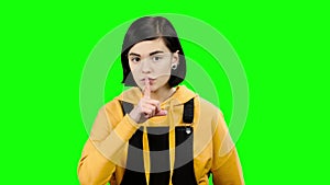 Girl shows a soft finger. Green screen