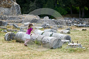 A girl sightseeing historical ruins of Asclepieion