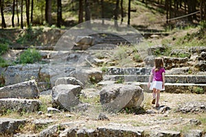 A girl sightseeing historical ruins of Asclepieion