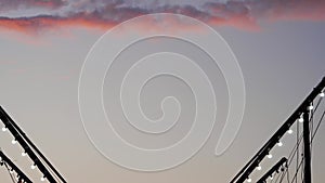 Girl silhouette is jumping on bungee trampoline against twilight sky: slow mo