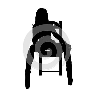 Girl silhouette posing and sittinog on chair