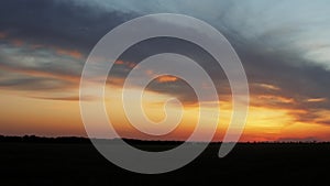 Girl silhouette at sunset walking in field of wheat, young woman in solitude on nature, concept lifestyle, meditating