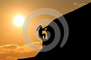 Girl silhouette on top of a mountain climb