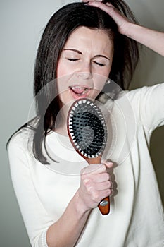 Girl singing on the hair brush