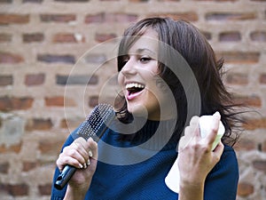 Girl singing on the hairbrush