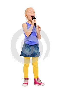 Girl singing karaoke in microphone and standing