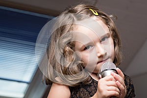 Girl singing on a microphone