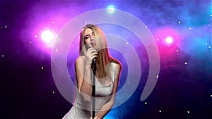 Girl singing into retro microphone with smoke effect. Slow motion