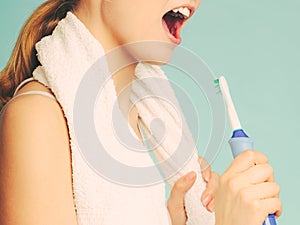 Girl singing using toothbrush.