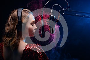 Girl sings into a microphone. Screensaver for a vocal school, work and training in vocals. Singing and lesson in music. Bright