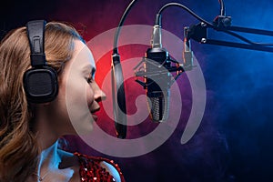 Girl sings into a microphone. Screensaver for a vocal school, work and training in vocals. Singing and lesson in music. Bright