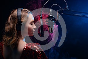 Girl sings into a microphone. Screensaver for a vocal school, work and training in vocals. Singing and lesson in music. Bright photo